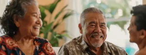 a senior couple smiling as they discuss financial options with a real estate agent in a sunny miami living room.