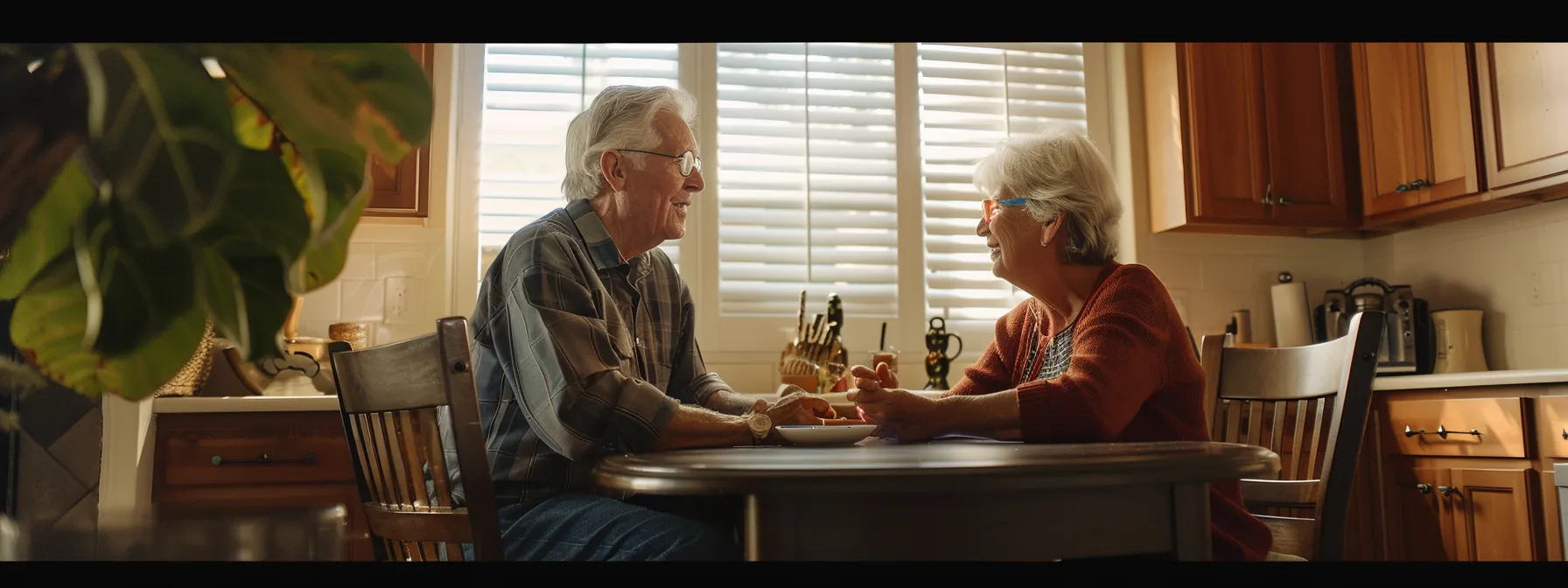 a senior couple sitting at a kitchen table in miami discussing their reverse mortgage options.