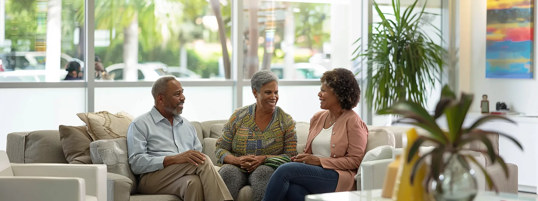 a senior couple receiving financial counseling in a bright, modern office setting in miami.